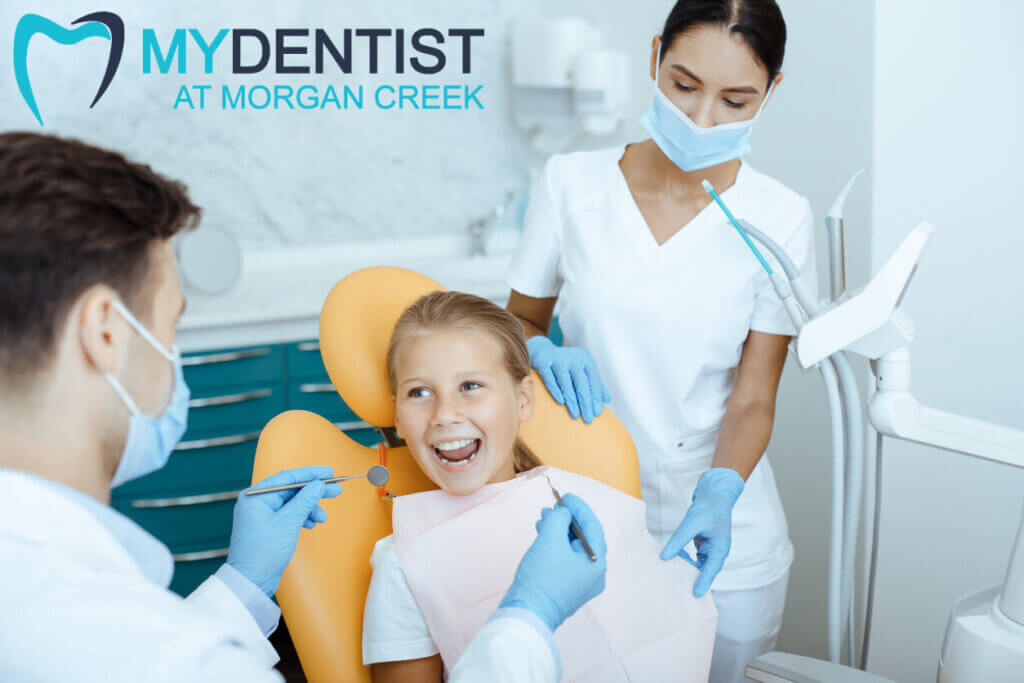 happy child sitting in dental chair